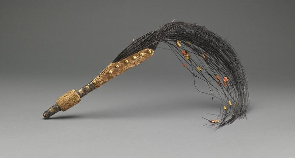 A 19th century elephant tail whisk of the African Asante people features a leather handle and beading. 