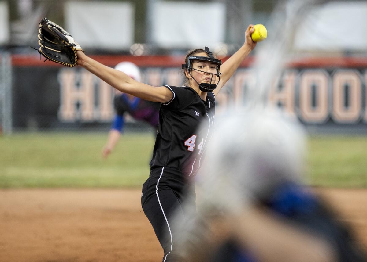 Huntington Beach's Zoe Prystajko pitches during a Surf League game against Los Alamitos at Huntington Beach High School on Tuesday, March 22.