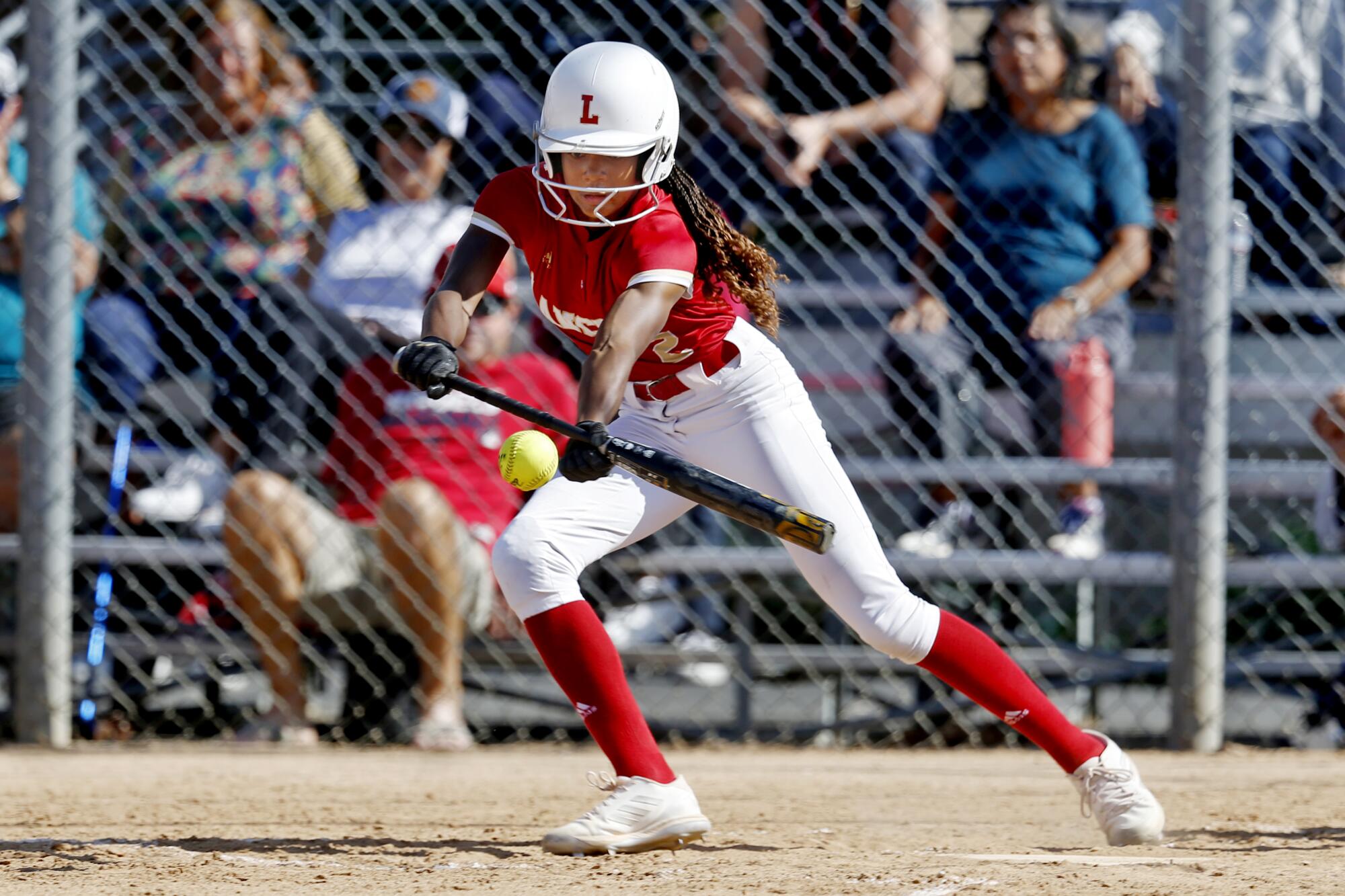 Orange Lutheran center fielder Kai Minor lays down a drag bunt during a game last season against Santa Margarita.