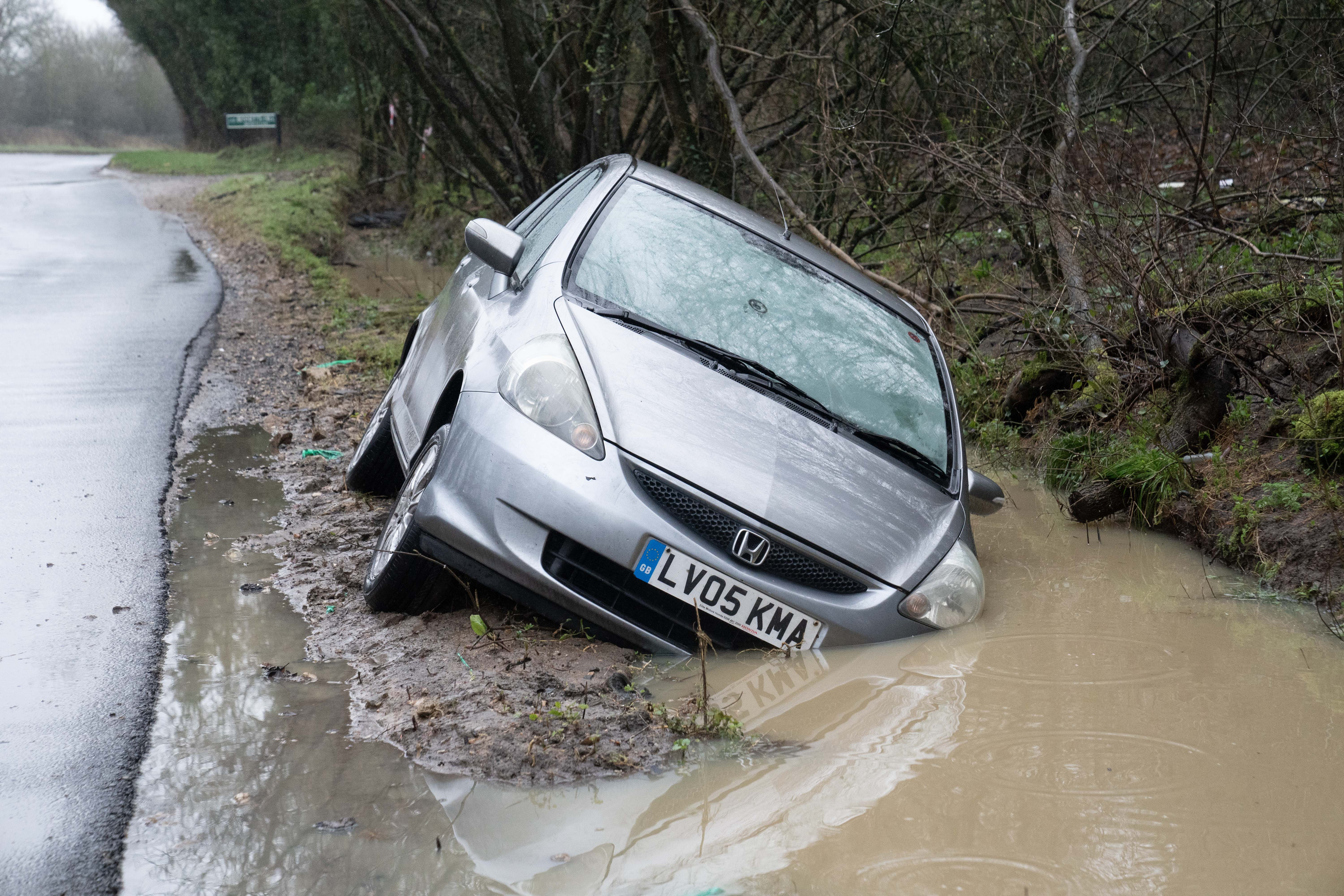 A car is seen on what was a flooded road the night before in Reading, Berkshire