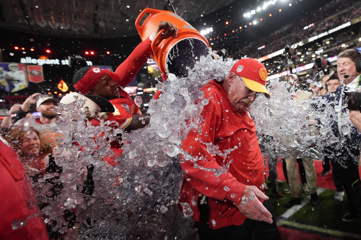 Chiefs head coach Andy Reid is splashed with the drinking bucket after a Super Bowl LVIII win over the 49ers.