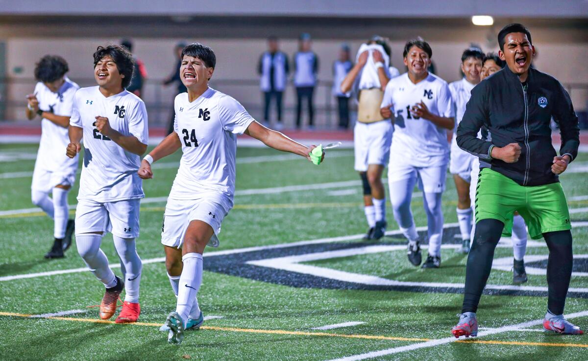 Eduardo Villegas (24) leads a celebration of Contreras soccer players after clinching first league title in school history.