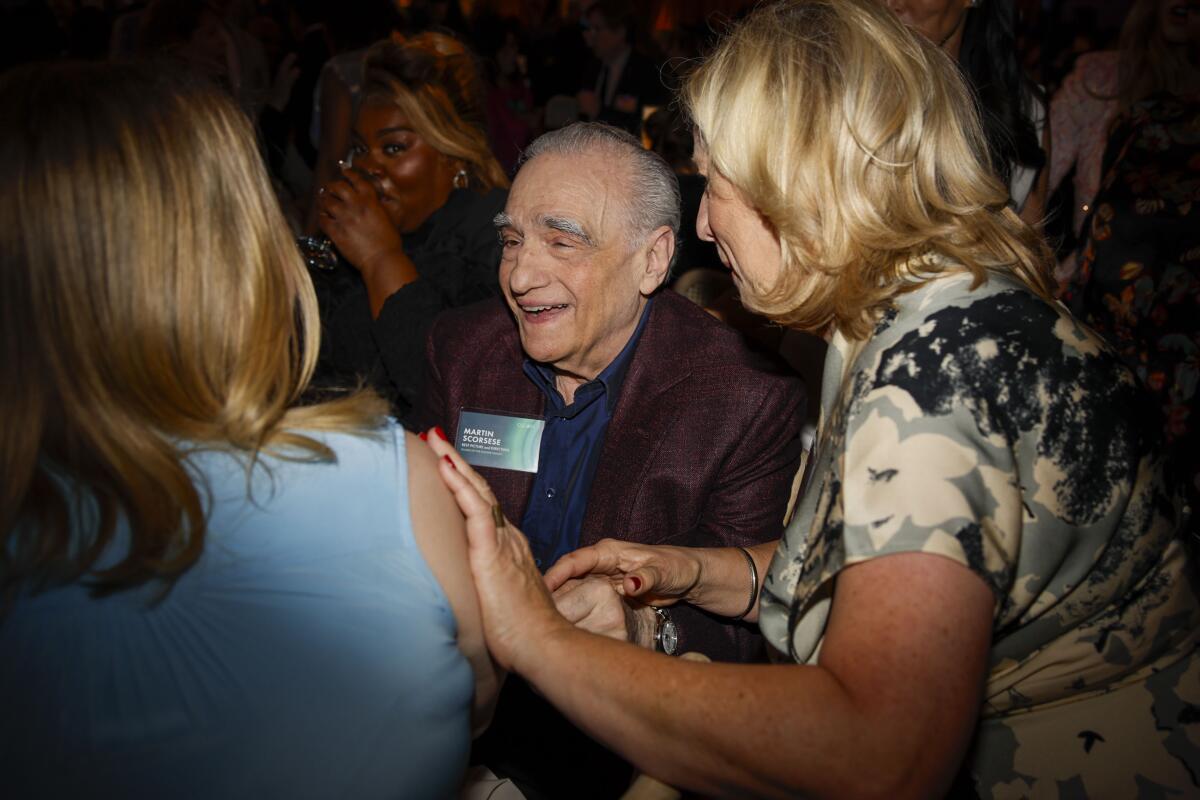 A smiling director chats at a luncheon.