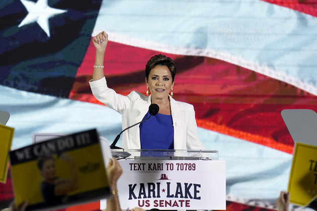 Republican candidate Kari Lake waves to supporters.