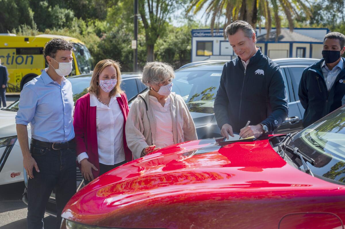 Gov. Gavin Newsom signs an executive order requiring all new passenger cars sold in California to be zero-emission by 2035.