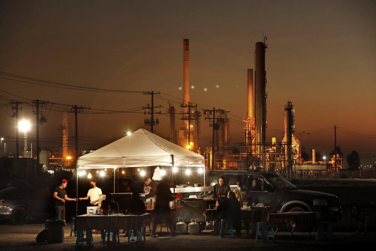 A taco stand operates near an oil refinery in California's Kern County.