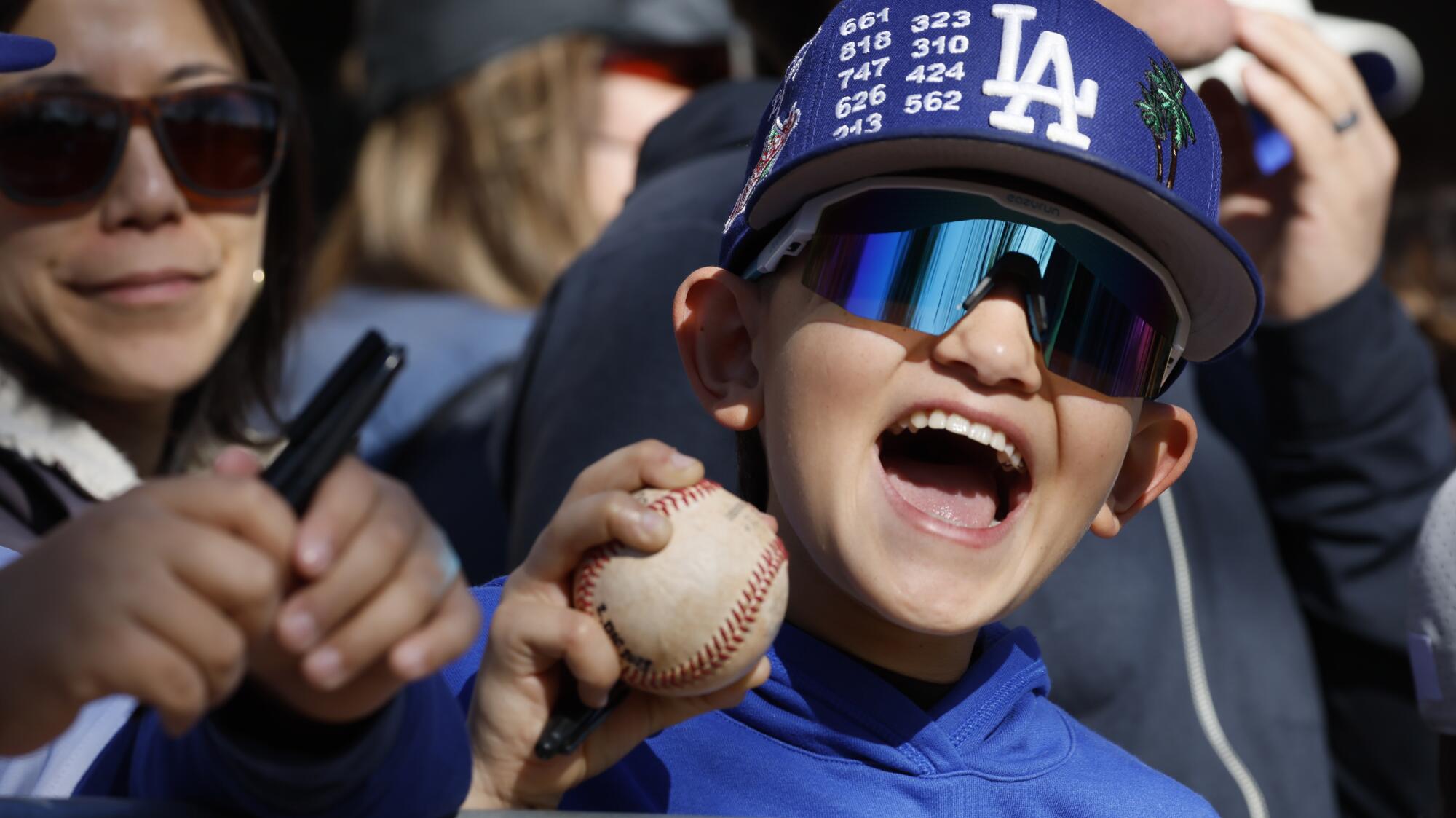 Christian Bujand, 10, crowds along with numerous other fans hoping for an autograph from Shoehei Ohtani.