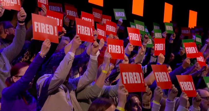 The majority of the audience held up 'fired' boards