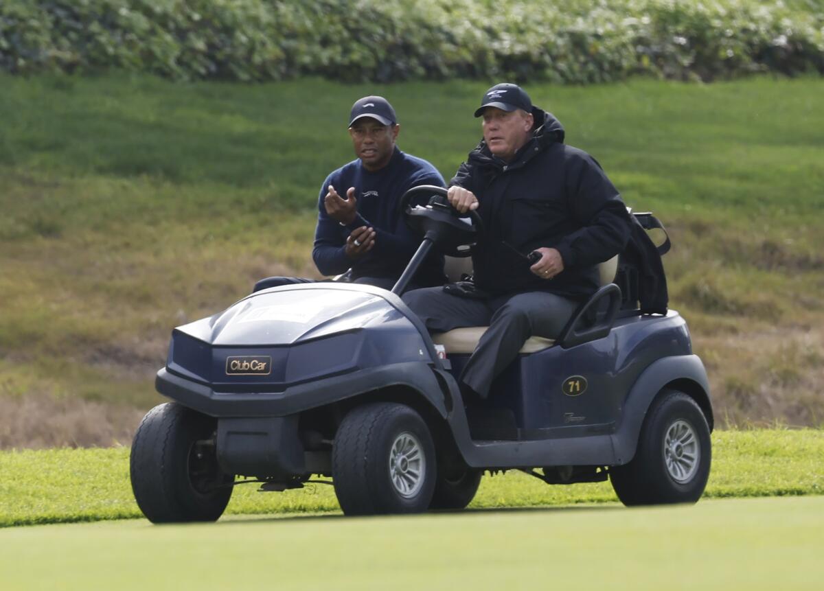 Pacific Palisade, CA - February 16: Tiger Woods is driven off the course after withdrawing.