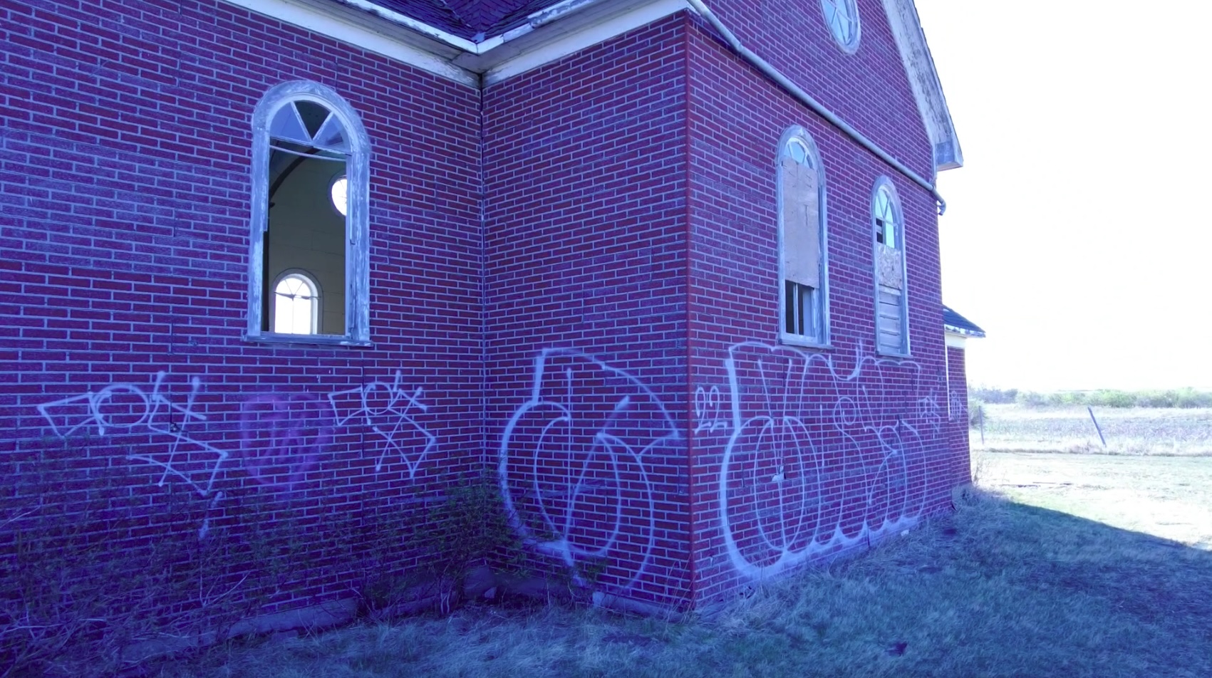 The facade of the church is covered in graffiti