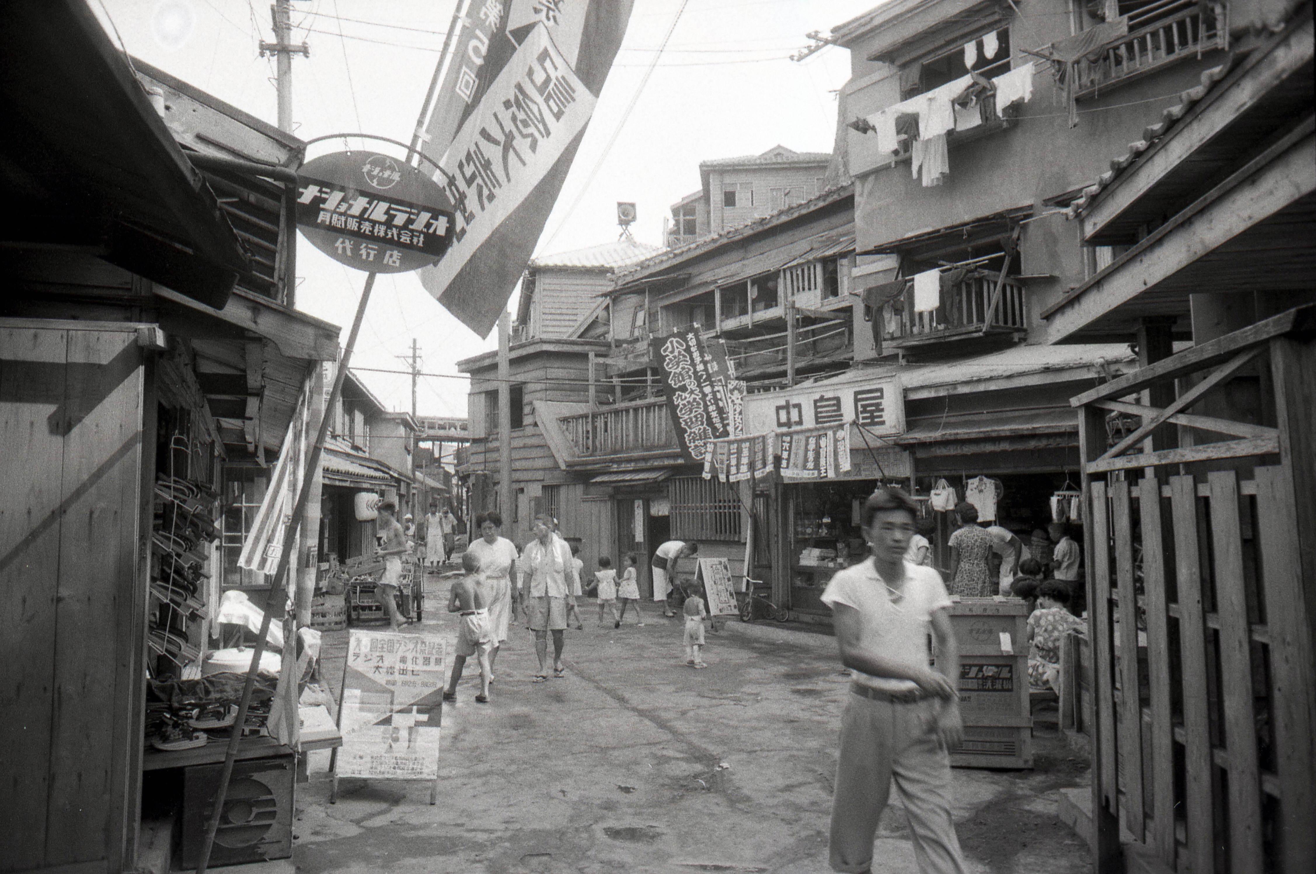 People walk a shopping street at Hashima on August 12, 1956 in Takashima, Nagasaki