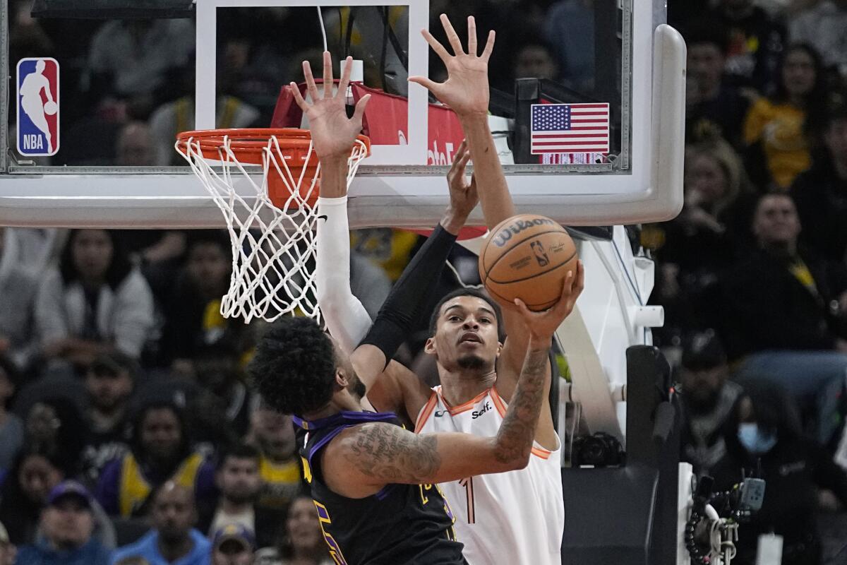 Spurs center Victor Wembanyama tries to block a shot by Lakers forward Christian Wood.