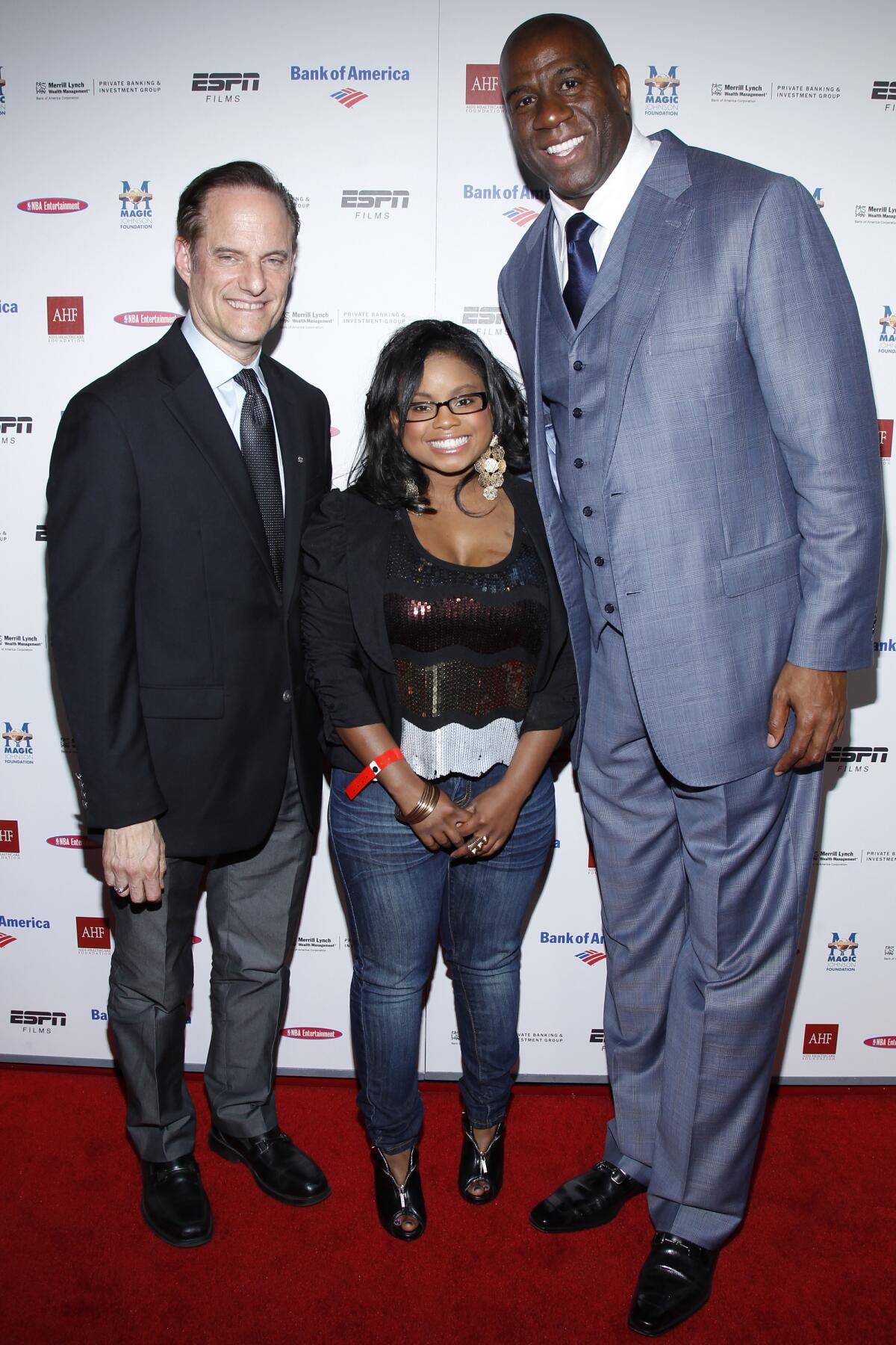 Michael Weinstein, left, Hydeia Broadbent, center, and Magic Johnson, right attend the premiere of 'The Announcement'