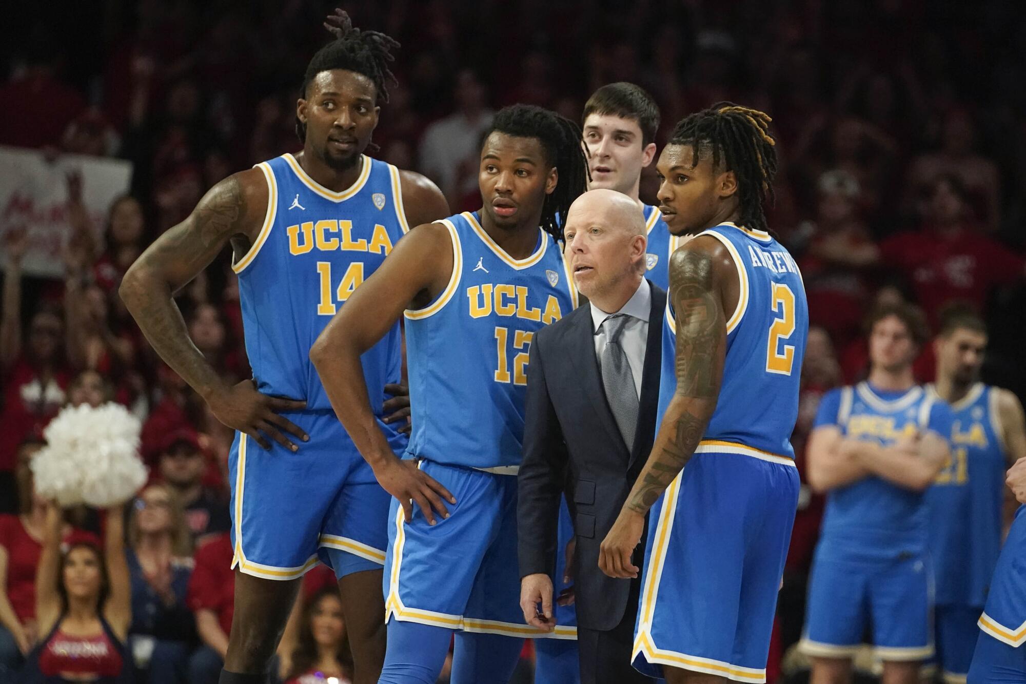 UCLA coach Mick Cronin and players await a call against Arizona on Jan. 20