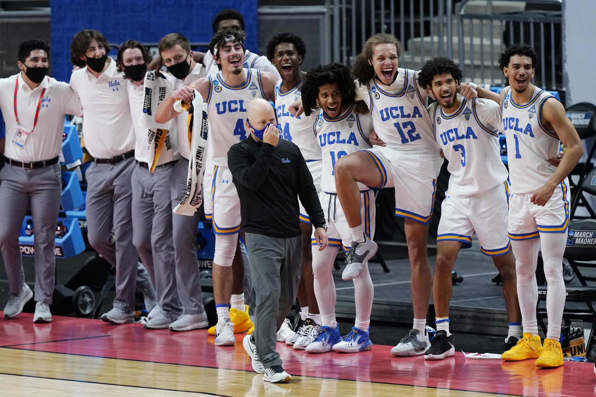 UCLA coach Mick Cronin and some of his players watch the final moments of the Bruins' win over Abilene Christian