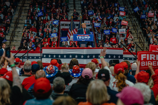 Former President Donald Trump speaks to a room of supporters at Winthrop Coliseum during a campaign event.