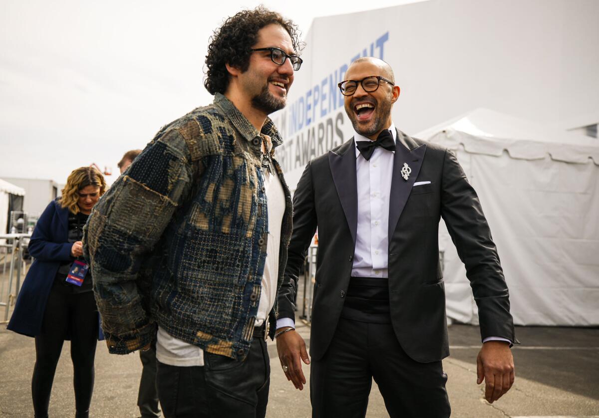 Two men laugh at an awards show.