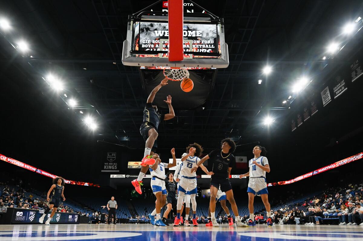 Mercy Miller of Sherman Oaks Notre Dame gets dunk in Division 1 final against Windward.