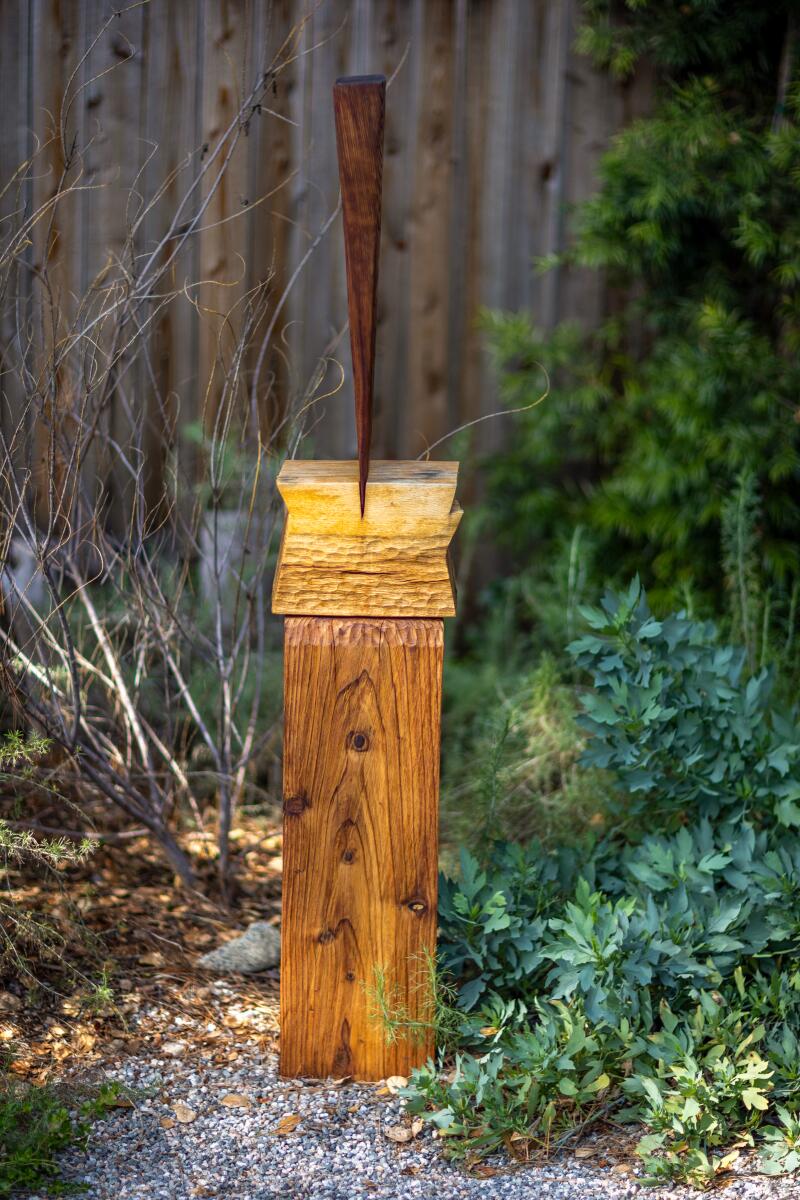 Detail of backyard native plants and outdoor artwork made by Vince Skelly.