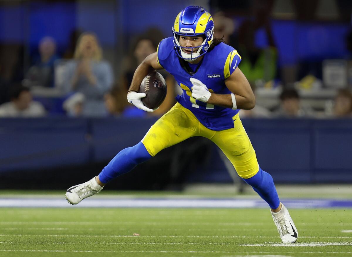 Rams wide receiver Puka Nacua carries the football against the Saints.