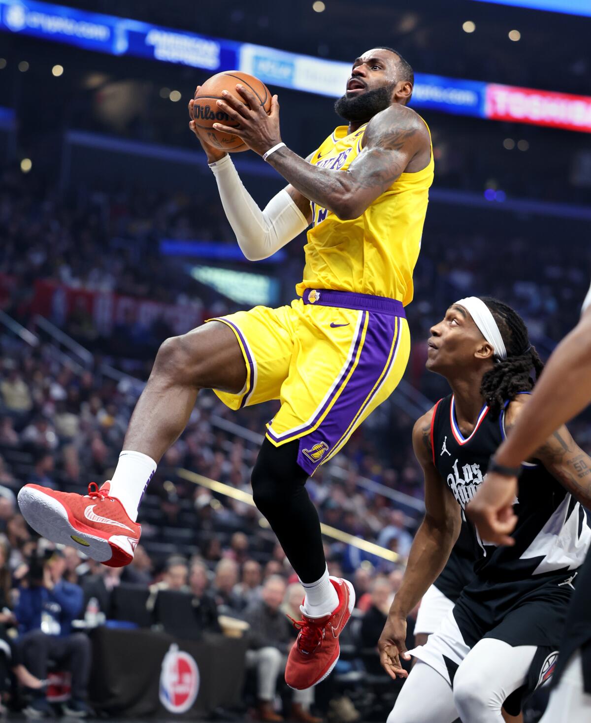 LeBron James beats Terance Mann for a basket in the second quarter.