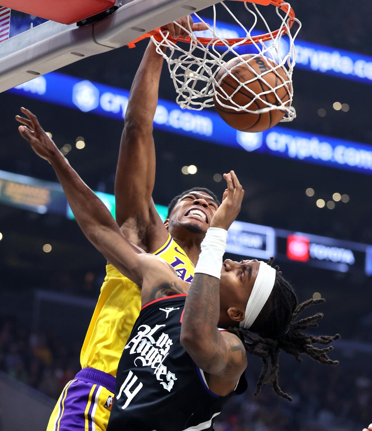 Rui Hachimura of the Lakers dunks over Terance Mann.