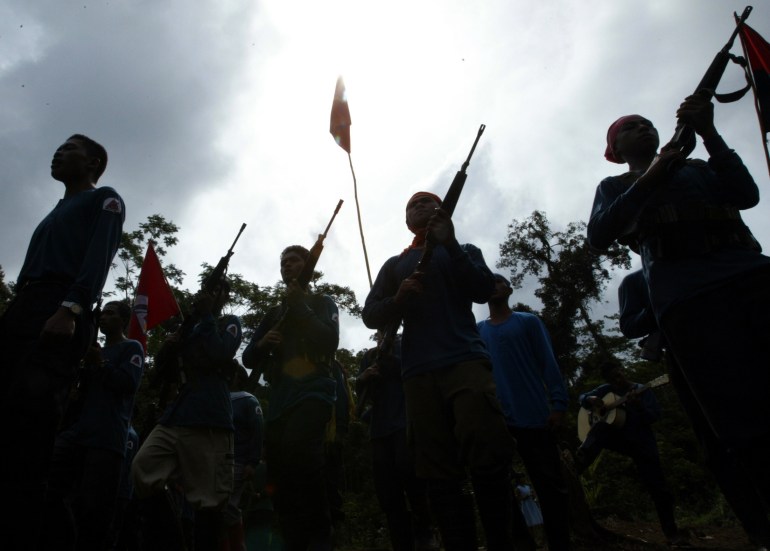 NPA fighters with their weapons silhouetted against the sky 