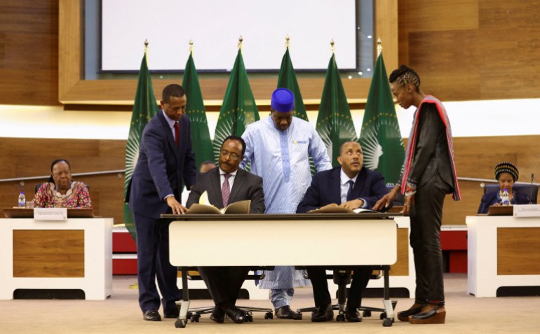 Ethiopian government representative Redwan Hussein and Tigray delegate Getachew Reda attend signing of the AU-led negotiations in South Africa