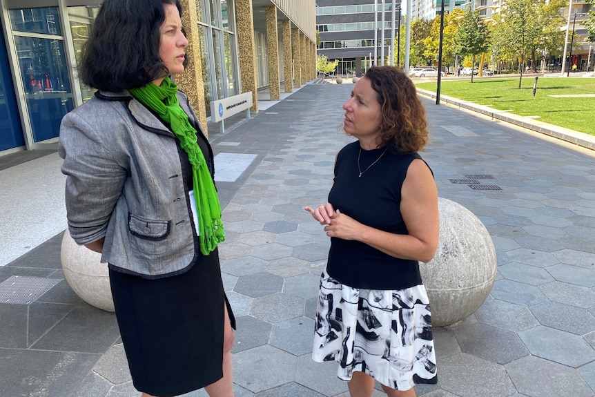 Two female politicians in discussion.