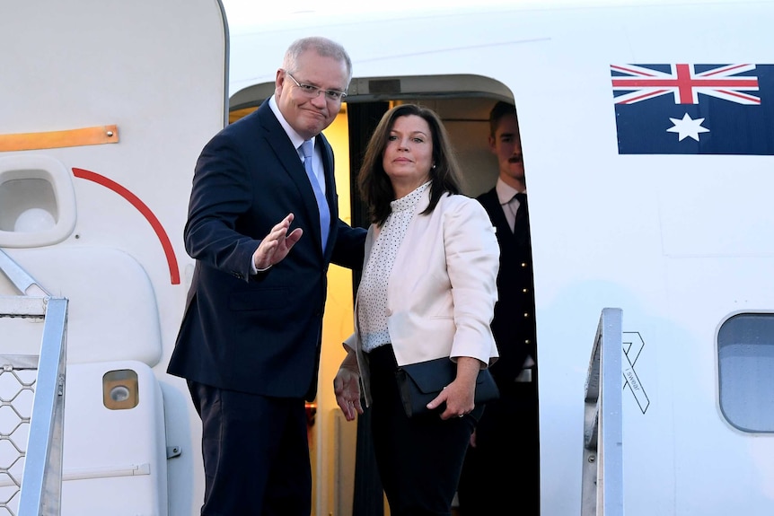 Scott and Jenny Morrison board a jet.