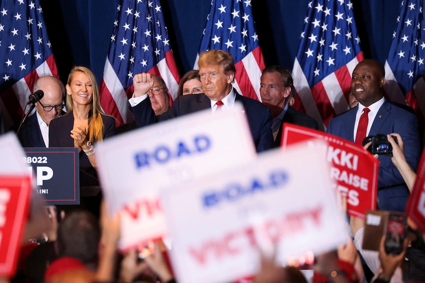 Trump raises his fist after winning the south carolina republican primary.