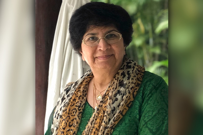 A portrait photo of Samina Yasmeen wearing a green top. 