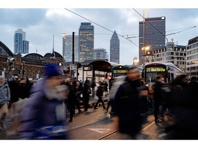 Commuters cross a road outside Frankfurt Central Station in Frankfurt, Germany, on Friday, Jan. 19, 2024. Germany's struggle to revive its sluggish economy is about to take an experimental turn as a host of companies take part in a pilot to work a 4-day week, with labor unions claiming that it could not only leave staff healthier and happier, but also more productive. Photographer: Ben Kilb/Bloomberg