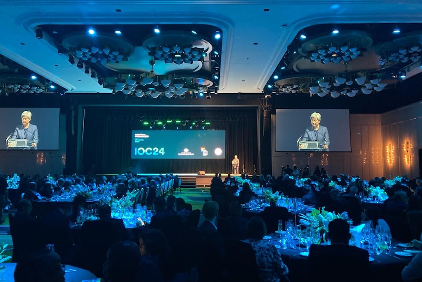 Penny Wong delivering a speech in an auditorium.