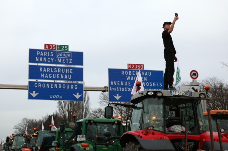 Farmers drive their tractors during a protest