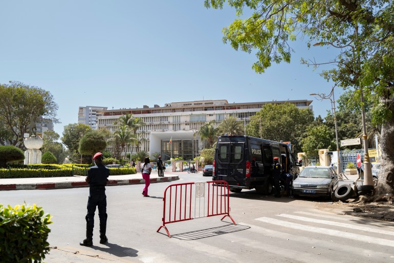 A view of the National Assembly in Dakar. Soldiers are standing guard. There is a military vehicle to one side