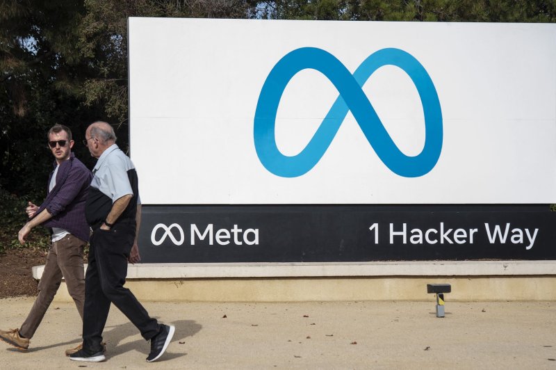 People walk by a sign on the Meta campus In Menlo Park, Calif., in 2022. Meta announced that it has expanded its election disinformation team in Europe ahead of parliamentary elections there. File Photo by Terry Schmitt/UPI