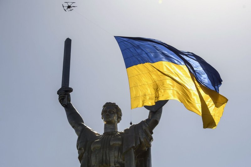 A drone flying a giant Ukrainian national flag passes over the Motherland Monument in Kyiv in 2022. Canada announced on Monday that it is donating hundreds of drones to Ukraine as it struggles to defeat invading Russia. File Photo by Vladyslav Musiienko /UPI