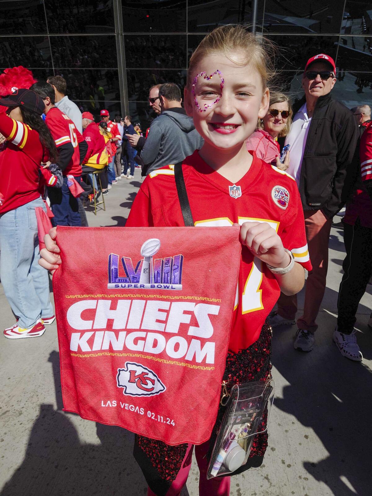 A girl poses with Super Bowl merch