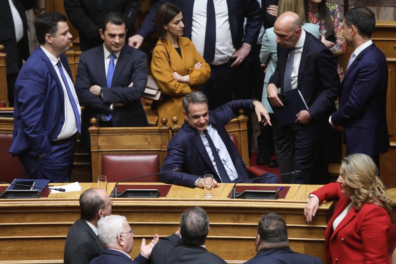 Greek Prime Minister Kyriakos Mitsotakis talks with members of the government after the debate on a bill legalizing same-sex marriage that was passed 176-76. Photo by George Vitsaras/EPA-EFE