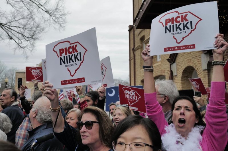 Mindy Ellmer (R), a member of the Women for Nikki coalition, energizes the crowd as Nikki Haley’s campaign bus pulls up in front of the Newberry Opera House in Newberry, S.C., on Saturday morning. Photo by Yiqing Wang/Medill News Service