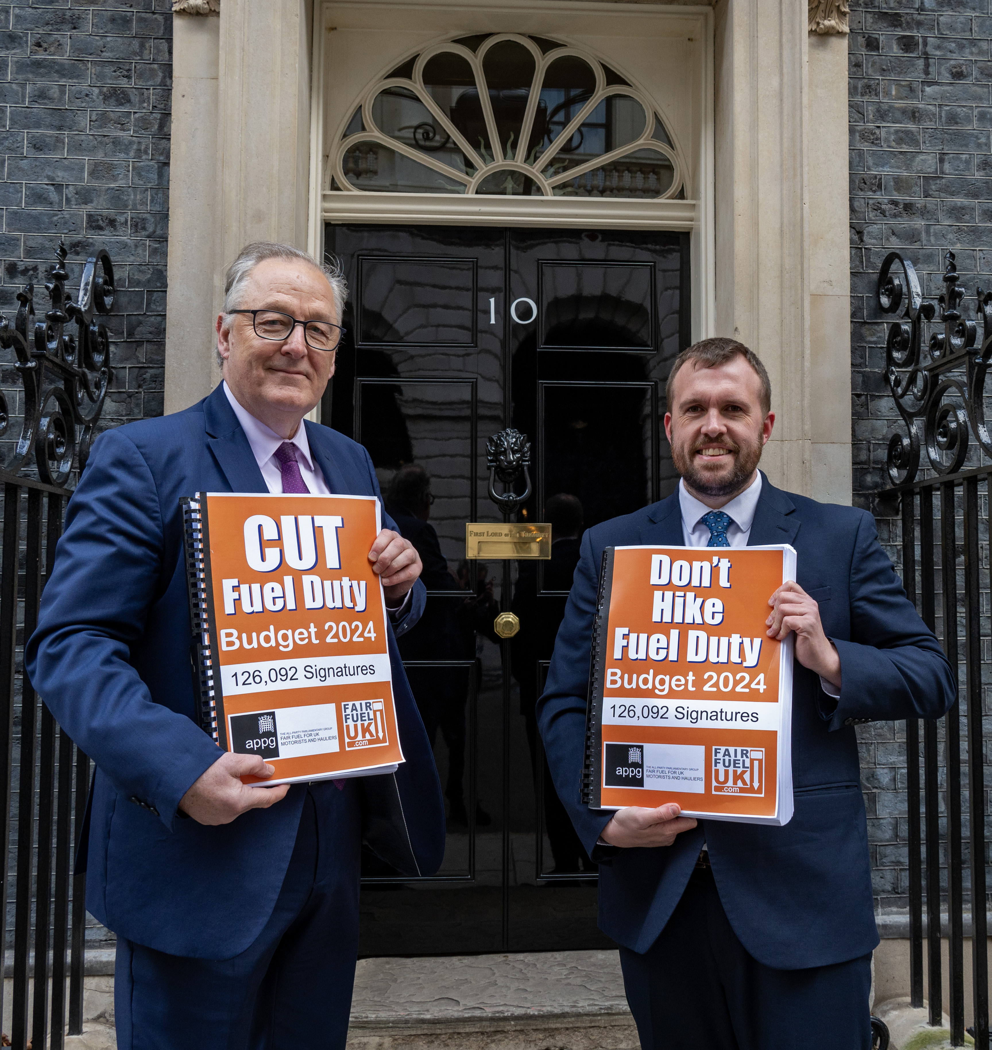 Fair Fuel UK founder Howard Cox, left, and Conservative MP Jonathan Gullis, right, outside No 10 Downing Street to hand over in a petition campaigning for a cut in fuel duty