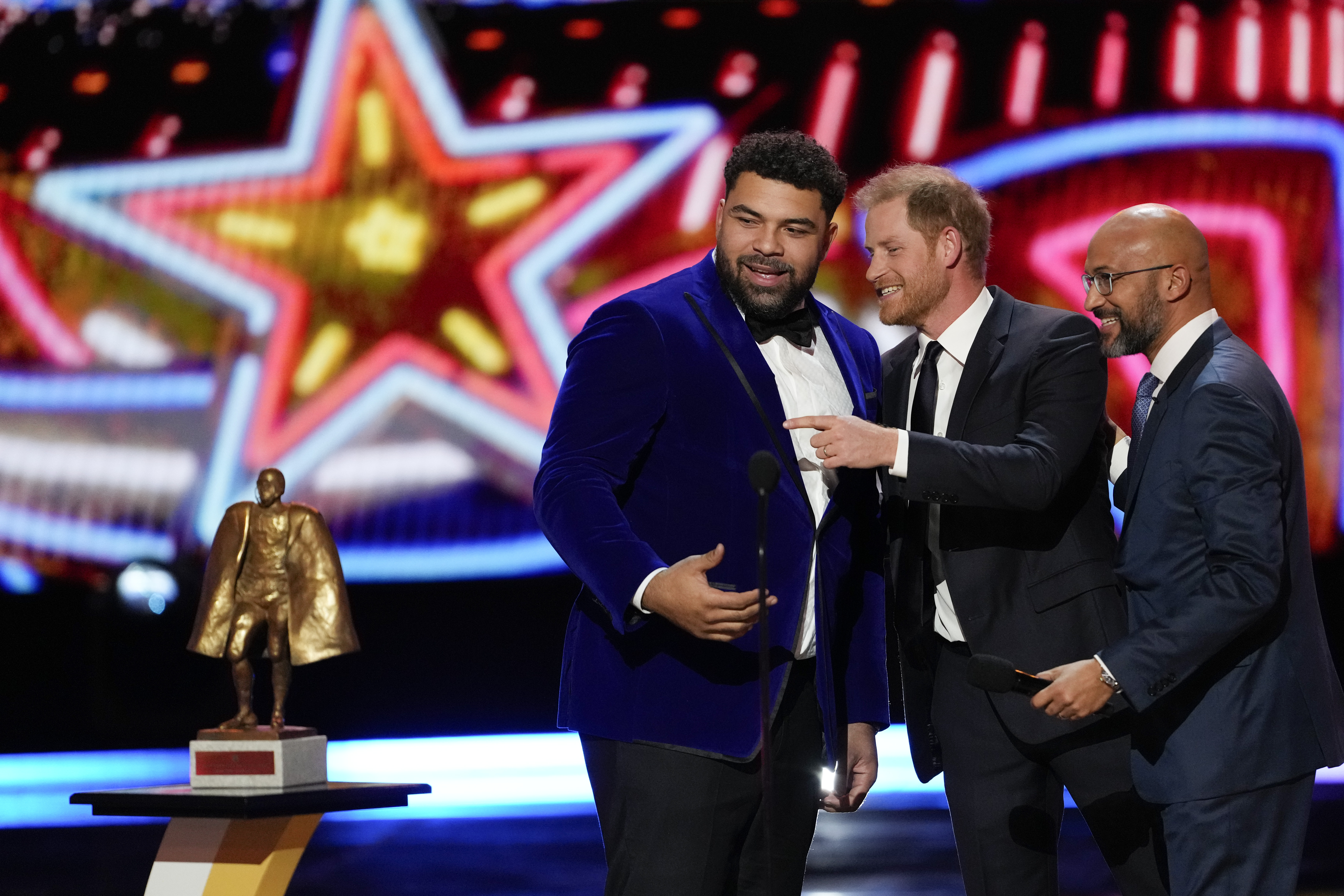 Prince Harry speaks to Pittsburgh Steelers’ Cameron Heyward, left, as Keegan-Michael Key looks on during the NFL Honors award show