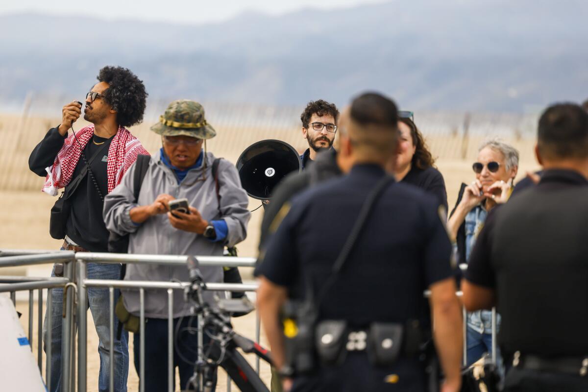 A man speaks into a loudspeaker.