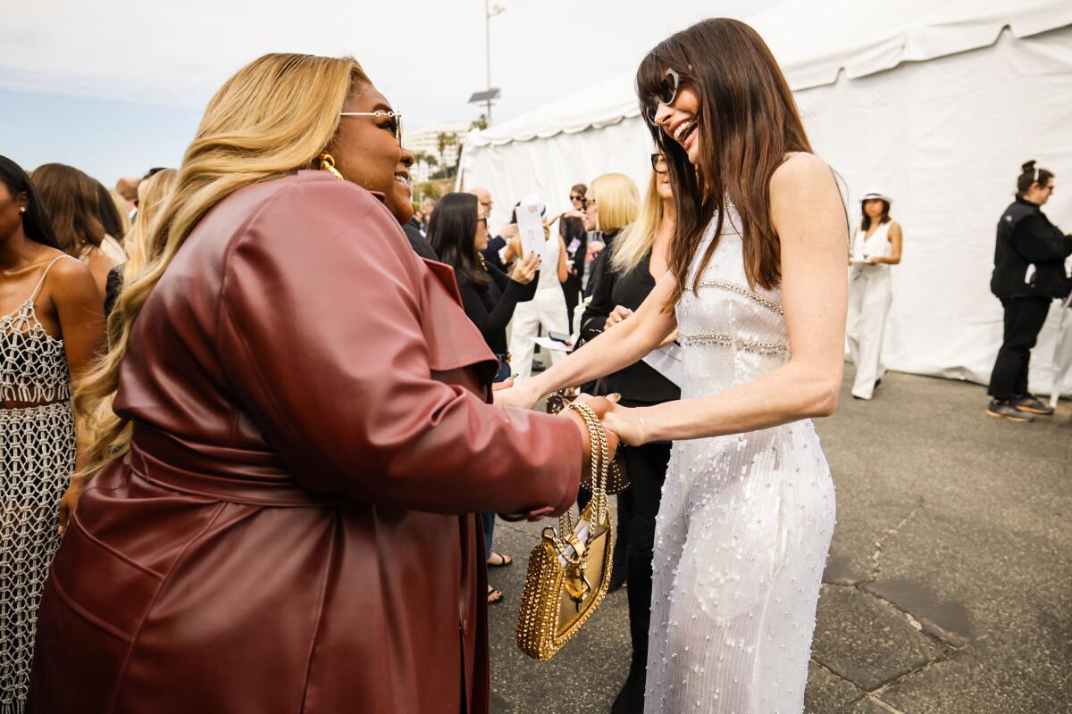 Two actors greet each other.