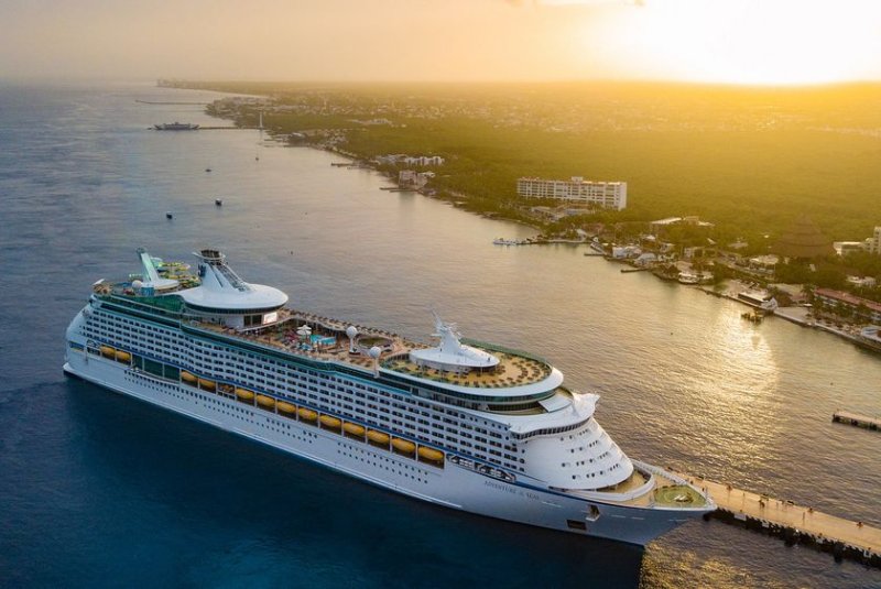 The Royal Caribbean ship Adventure of the Seas docks in Mexico in 2021. The company reported almost $14 billion in total revenue Thursday, on the back of strong demand and record-breaking bookings, a trend it expects to continue this year. File Photo by Heyder Castillo/EPA-EFE