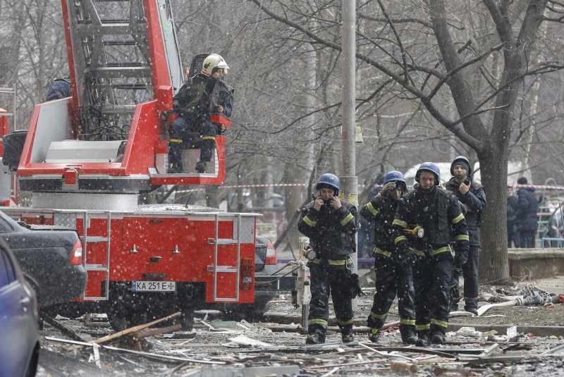 Officials said at least four people were killed in Kyiv, where firefighters are seen here responding to the scene of a building damaged by debris from a fallen drone, after Russian strikes targeting some of Ukraine's major cities. Photo by Sergey Dolzhenko/EPA-EFE