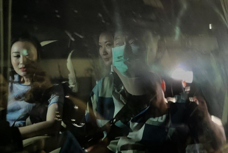 Former Thai Prime Minister Thaksin Shinawatra (R) sits inside a van as he departs Police General Hospital in Bangkok, Thailand, on Sunday. The convicted former prime minister was among 930 prisoners freed from prison on parole, due to his age and "serious illness." Photo by EPA-EFE