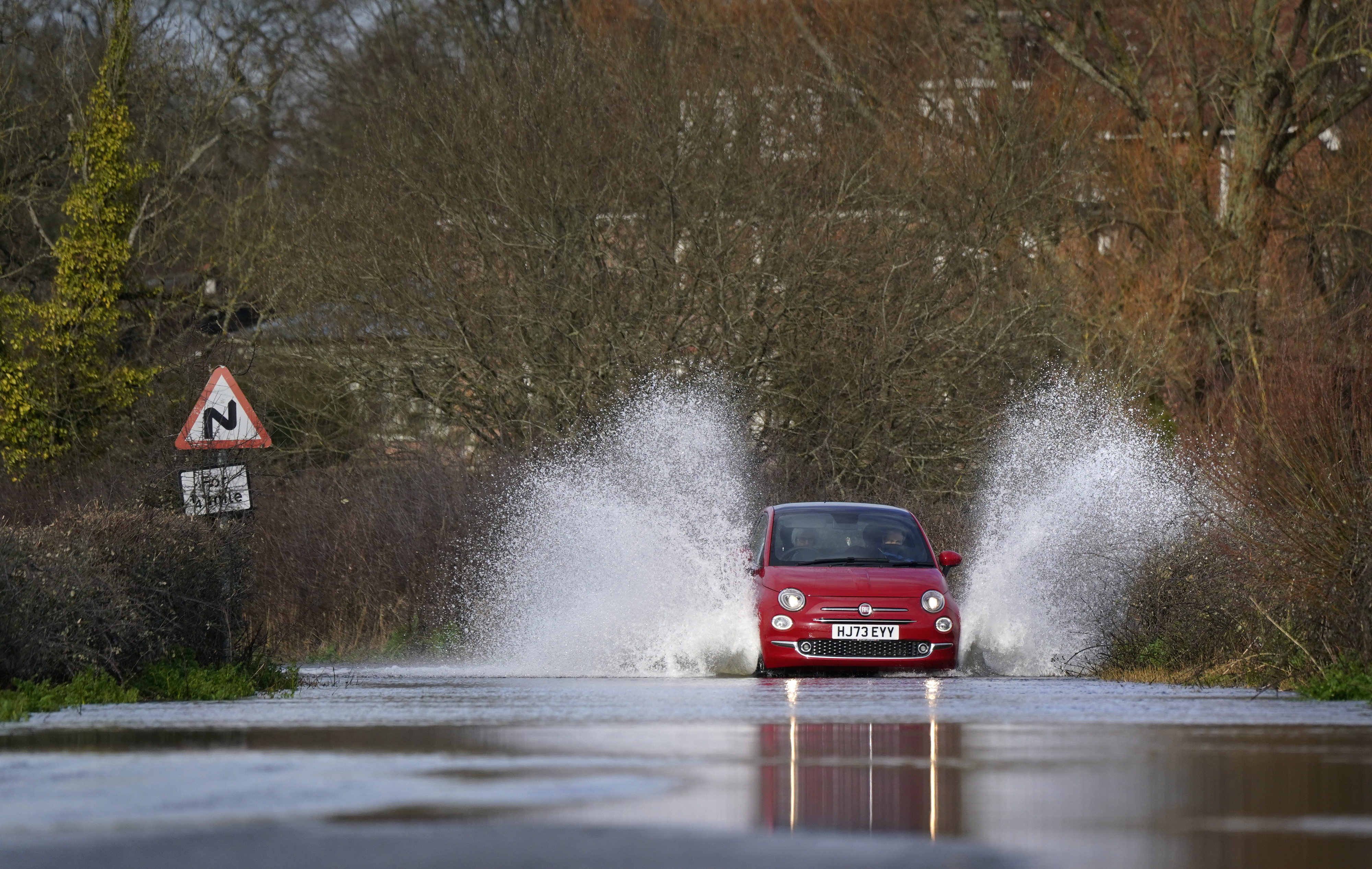 18-hours of torrential downpours threaten to cut off major routes, like this scene Harbridge, Hampshire, on Friday