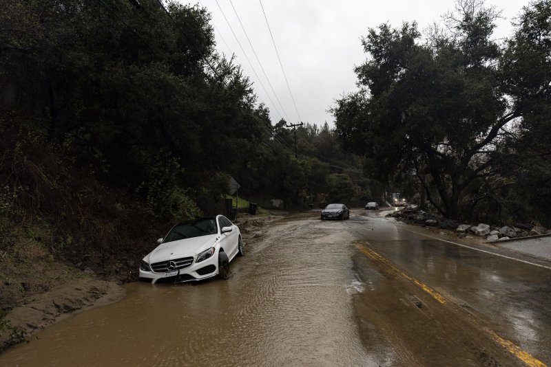 Vehicles impacted by a mudslide are abandoned on the road as a storm sweeps through Southern California, bringing torrential rains and high winds, in Topanga, Calif., on Monday Downtown Los Angeles recorded 5.62 inches of rain in 24 hours. Remnants of the storm moved east into Arizona, New Mexico, Oklahoma and Texas. Photo by Etienne Laurent/EPA-EFE